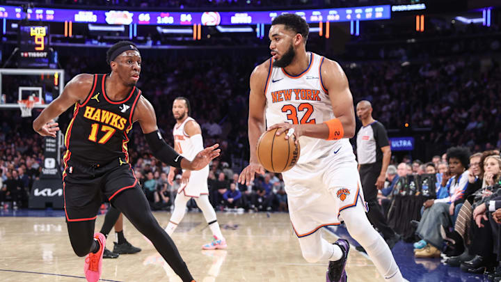 Feb 12, 2025; New York, New York, USA;  New York Knicks center Karl-Anthony Towns (32) looks to drive past Atlanta Hawks forward Onyeka Okongwu (17) in the second quarter at Madison Square Garden. Mandatory Credit: Wendell Cruz-Imagn Images