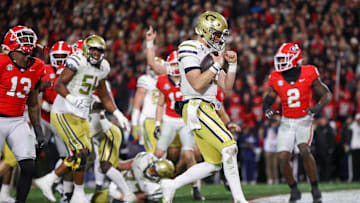 Nov 29, 2024; Athens, Georgia, USA; Georgia Tech Yellow Jackets quarterback Haynes King (10) runs for a touchdown against the Georgia Bulldogs in the second quarter at Sanford Stadium. Mandatory Credit: Brett Davis-Imagn Images