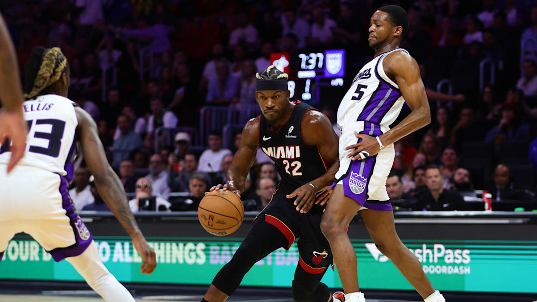 Nov 4, 2024; Miami, Florida, USA; Miami Heat forward Jimmy Butler (22) drives to the basket past Sacramento Kings guard De'Aaron Fox (5) during the first quarter at Kaseya Center. 