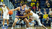 Michigan guard Nimari Burnett (4) tries to steal the ball from Northwestern guard Brooks Barnhizer (13) during the first half at Crisler Center in Ann Arbor on Sunday, Jan. 19, 2025.