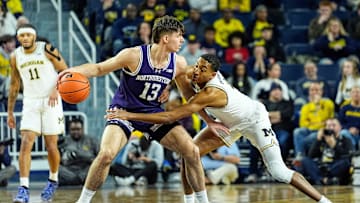 Michigan guard Nimari Burnett (4) tries to steal the ball from Northwestern guard Brooks Barnhizer (13) during the first half at Crisler Center in Ann Arbor on Sunday, Jan. 19, 2025.