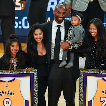 Dec 18, 2017; Los Angeles, CA, USA; Kobe Bryant (center) poses with his family Gianna Bryant, Vanessa Bryant, Bianka Bryant, and Natalia Bryant during a halftime ceremony retiring Kobe Bryant's two uniform numbers at Staples Center. Mandatory Credit: Robert Hanashiro-Imagn Images