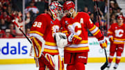 Apr 3, 2025; Calgary, Alberta, CAN; Calgary Flames goaltender Dustin Wolf (32) and Calgary Flames center Nazem Kadri (91) celebrates win over the Anaheim Ducks at Scotiabank Saddledome. Mandatory Credit: Sergei Belski-Imagn Images