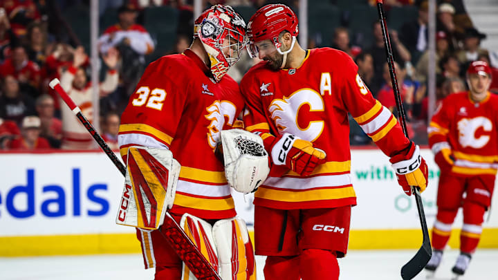 Apr 3, 2025; Calgary, Alberta, CAN; Calgary Flames goaltender Dustin Wolf (32) and Calgary Flames center Nazem Kadri (91) celebrates win over the Anaheim Ducks at Scotiabank Saddledome. Mandatory Credit: Sergei Belski-Imagn Images Apr 3, 2025; Calgary, Alberta, CAN; Calgary Flames goaltender Dustin Wolf (32) and Calgary Flames center Nazem Kadri (91) celebrates win over the Anaheim Ducks at Scotiabank Saddledome. Mandatory Credit: Sergei Belski-Imagn Images