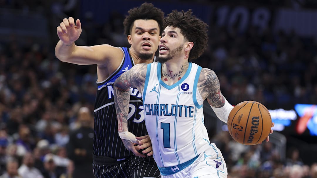 Jan 22, 2026; Orlando, Florida, USA; Charlotte Hornets guard LaMelo Ball (1) drives the ball past Orlando Magic forward Noah Penda (93) in the fourth quarter at Kia Center. Mandatory Credit: Nathan Ray Seebeck-Imagn Images