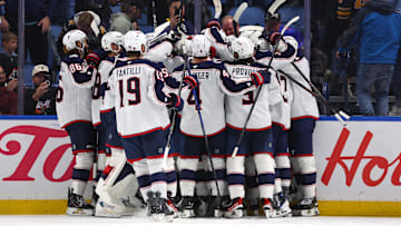 The Blue Jackets celebrate after an overtime win against the Buffalo Sabres