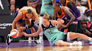 Sep 19, 2025; Phoenix, Arizona, USA; Phoenix Mercury forward Satou Sabally (0) and New York Liberty forward Leonie Fiebich (13) go after a loose ball during the second half of game three of round one for the 2025 WNBA Playoffs at PHX Arena. Mandatory Credit: Joe Camporeale-Imagn Images