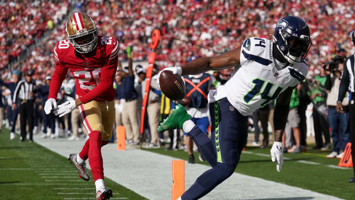 Dec 10, 2023; Santa Clara, California, USA; Seattle Seahawks wide receiver DK Metcalf (14) catches a touchdown in front of San Francisco 49ers cornerback Ambry Thomas (20) in the first quarter at Levi's Stadium. Mandatory Credit: Cary Edmondson-USA TODAY Sports