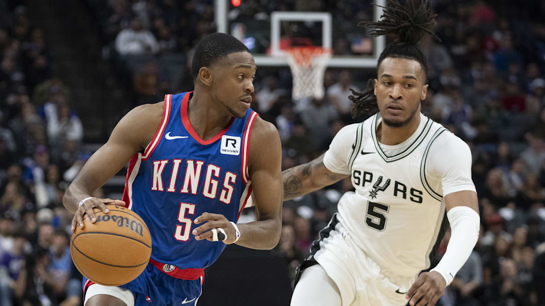December 1, 2024; Sacramento, California, USA; Sacramento Kings guard De'Aaron Fox (5) dribbles the basketball against San Antonio Spurs guard Stephon Castle (5) during the second quarter at Golden 1 Center. Mandatory Credit: Kyle Terada-Imagn Images