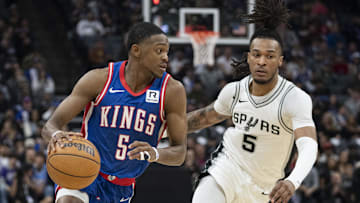 December 1, 2024; Sacramento, California, USA; Sacramento Kings guard De'Aaron Fox (5) dribbles the basketball against San Antonio Spurs guard Stephon Castle (5) during the second quarter at Golden 1 Center. Mandatory Credit: Kyle Terada-Imagn Images