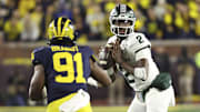 Oct 26, 2024; Ann Arbor, Michigan, USA;  Michigan Wolverines defensive end Cameron Brandt (91) pressures Michigan State Spartans quarterback Aidan Chiles (2) in the second half at Michigan Stadium. Mandatory Credit: Rick Osentoski-Imagn Images