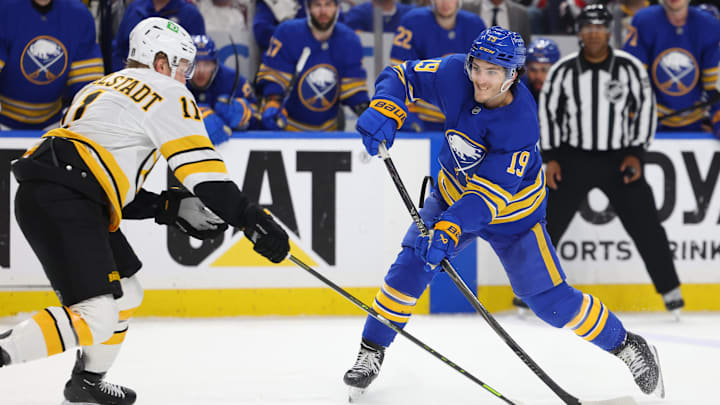 Apr 28, 2026; Buffalo, New York, USA; Boston Bruins center Casey Mittelstadt (11) tries to block a shot by Buffalo Sabres center Peyton Krebs (19) during overtime in game five of the first round of the 2026 Stanley Cup Playoffs at KeyBank Center. Mandatory Credit: Timothy T. Ludwig-Imagn Images