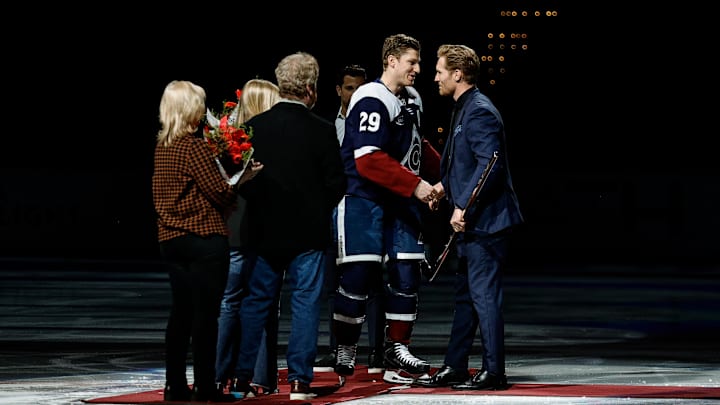 Nathan MacKinnon shakes hands with Gabriel Landeskog at center ice. Nathan MacKinnon shakes hands with Gabriel Landeskog at center ice.
