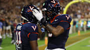 Sep 26, 2025; Charlottesville, Virginia, USA; Virginia Cavaliers wide receiver Trell Harris (11) celebrates with Cavaliers tight end Dakota Twitty (9) after catches a two point conversion as Florida State Seminoles defensive back Jerry Wilson (19) defends in the second overtime period at Scott Stadium. Mandatory Credit: Geoff Burke-Imagn Images