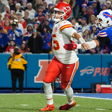 Nov 2, 2025; Orchard Park, New York, USA;  Kansas City Chiefs quarterback Patrick Mahomes (15) is pressured to throw by Buffalo Bills defensive end A.J. Epenesa (57)