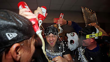Oct 31, 2024; New York, New York, USA; Los Angeles Dodgers two-way player Shohei Ohtani (17) celebrates in the locker room after the Los Angeles Dodgers beat the New York Yankees in game four to win the 2024 MLB World Series at Yankee Stadium. 