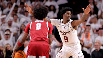 Jan 11, 2025; College Station, Texas, USA; Texas A&M Aggies forward Solomon Washington (9) defends against Alabama Crimson Tide guard Labaron Philon (0) during the first half at Reed Arena. Mandatory Credit: Erik Williams-Imagn Images