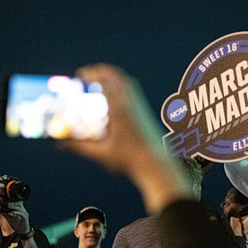 Purdue Boilermakers guard Fletcher Loyer holds up a March Madness sign to the crowd last season.