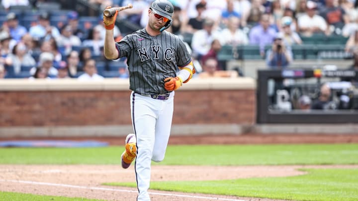 May 25, 2024; New York City, New York, USA;  New York Mets first baseman Pete Alonso (20) throws his bat after flying out to end the seventh inning against the San Francisco Giants at Citi Field. Mandatory Credit: Wendell Cruz-Imagn Images