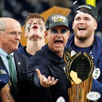 Jan 8, 2024; Houston, TX, USA; Michigan Wolverines head coach Jim Harbaugh celebrates with the CFP Championship trophy after beating the Washington Huskies in the 2024 College Football Playoff national championship game at NRG Stadium. Mandatory Credit: Kirby Lee-USA TODAY Sports