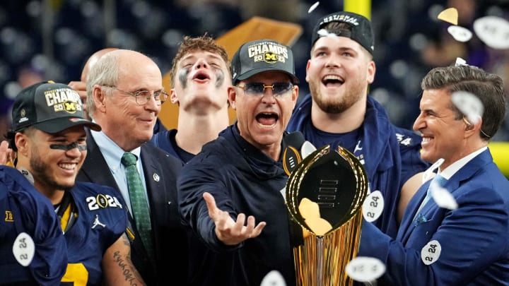 Jan 8, 2024; Houston, TX, USA; Michigan Wolverines head coach Jim Harbaugh celebrates with the CFP Championship trophy after beating the Washington Huskies in the 2024 College Football Playoff national championship game at NRG Stadium. Mandatory Credit: Kirby Lee-USA TODAY Sports