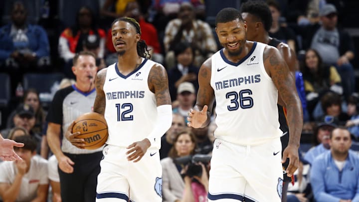 Oct 18, 2024; Memphis, Tennessee, USA; Memphis Grizzlies guard Ja Morant (12) and guard Marcus Smart (36) react during the first half against the Miami Heat at FedExForum. Mandatory Credit: Petre Thomas-Imagn Images