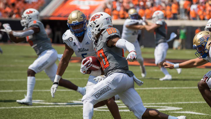 Sep 11, 2021; Stillwater, Oklahoma, USA;  Oklahoma State Cowboys wide receiver Brennan Presley (80) looks to get around Tulsa Golden Hurricane cornerback Kenney Solomon (5) during the fourth quarter at Boone Pickens Stadium. The Cowboys won 28-23. Mandatory Credit: Brett Rojo-Imagn Images