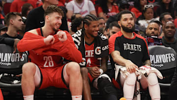 Apr 30, 2025; Houston, Texas, USA; From left to right, Houston Rockets center Alperen Sengun (28) guard Jalen Green (4) and guard Fred VanVleet (5) smile from the bench as their teammates play against the Golden State Warriors in the third quarter during game five of first round for the 2025 NBA Playoffs at Toyota Center. Mandatory Credit: Thomas Shea-Imagn Images