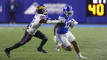 Nov 16, 2024; Provo, Utah, USA; Brigham Young Cougars wide receiver Keelan Marion (17) is tackled after a catch by Kansas Jayhawks cornerback Cobee Bryant (2) during the second quarter at LaVell Edwards Stadium. Mandatory Credit: Rob Gray-Imagn Images