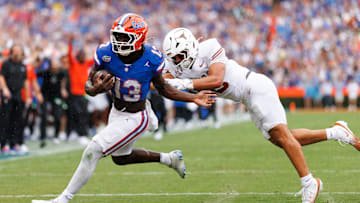 Oct 4, 2025; Gainesville, Florida, USA; Florida Gators running back Jadan Baugh (13) breaks a tackle from Texas Longhorns linebacker Liona Lefau (18) during the first half at Ben Hill Griffin Stadium. Mandatory Credit: Matt Pendleton-Imagn Images