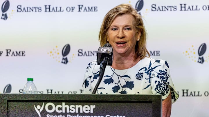 Jun 18, 2025; New Orleans, LA, USA;  Former WGNO Sports Director Ed Daniels wife, Robin Daniels, accepts the Joe Gemelli Fleur de Lis Award during the New Orleans Saints Hall of Fame press conference. Mandatory Credit: Stephen Lew—Imagn Images