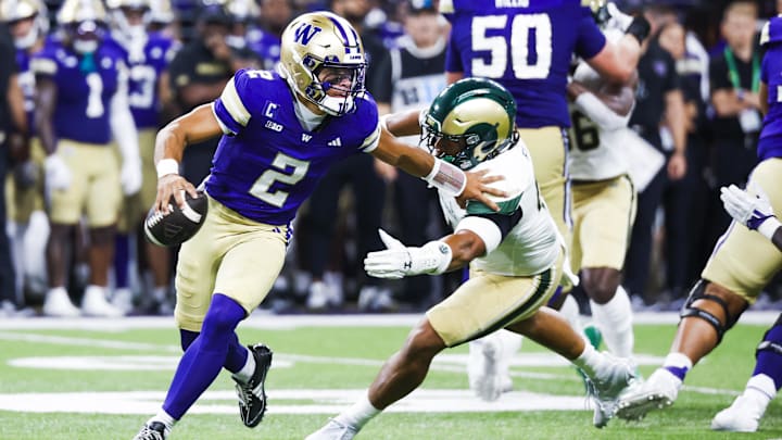 Aug 30, 2025; Seattle, Washington, USA; Washington Huskies quarterback Demond Williams Jr. (2) escapes a potential sack by Colorado State Rams linebacker Jacob Ellis (44) during the second quarter at Husky Stadium. Mandatory Credit: Joe Nicholson-Imagn Images