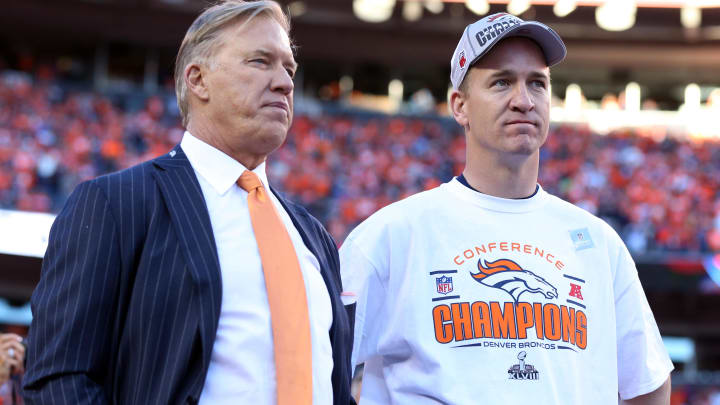 Jan 19, 2014; Denver, CO, USA; Denver Broncos executive vice president of football operations John Elway and quarterback Peyton Manning (18) after the 2013 AFC championship playoff football game against the New England Patriots at Sports Authority Field at Mile High. 