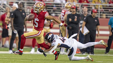 August 19, 2023; Santa Clara, California, USA; San Francisco 49ers quarterback Trey Lance (5) is tackled by Denver Broncos linebacker Justin Strnad (40) during the fourth quarter at Levi's Stadium. Mandatory Credit: Kyle Terada-Imagn Images