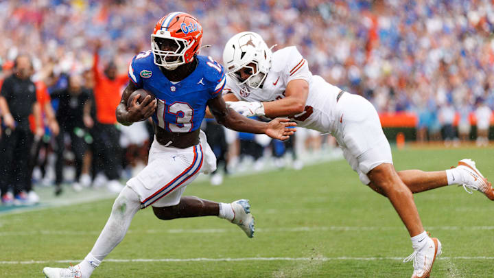 Oct 4, 2025; Gainesville, Florida, USA; Florida Gators running back Jadan Baugh (13) breaks a tackle from Texas Longhorns linebacker Liona Lefau (18) during the first half at Ben Hill Griffin Stadium. Mandatory Credit: Matt Pendleton-Imagn Images