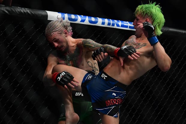 Kris Mountinho lands a knee hit against Sean O Malley during UFC 264 at T-Mobile Arena. 