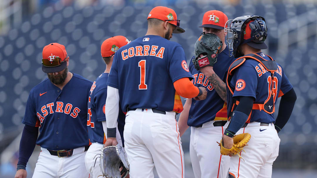 The Houston Astros infield has a meeting with pitcher Hunter Brown (58).