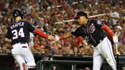 Washington Nationals center fielder Bryce Harper (34) is congratulated by left fielder Juan Soto (22) after scoring a run against the Miami Marlins during the fifth inning at Nationals Park in 2018.