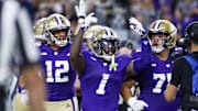 Aug 31, 2024; Seattle, Washington, USA; Washington Huskies running back Jonah Coleman (1) celebrates with wide receiver Denzel Boston (12) and offensive lineman D'Angalo Titialii (75) after rushing for a touchdown against the Weber State Wildcats during the third quarter at Alaska Airlines Field at Husky Stadium. Mandatory Credit: Joe Nicholson-Imagn Images