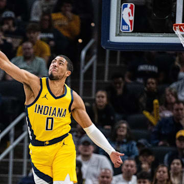 Nov 19, 2023; Indianapolis, Indiana, USA; Orlando Magic guard Anthony Black (0) shoots the ball while Indiana Pacers guard Tyrese Haliburton (0) defends in the first quarter at Gainbridge Fieldhouse. Mandatory Credit: Trevor Ruszkowski-Imagn Images