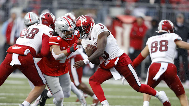 Nov 12, 2022; Columbus, Ohio, USA;  Indiana Hoosiers quarterback Dexter Williams II (5) runs the ball as Ohio State Buckeyes defensive end J.T. Tuimoloau (44) closes in to make the tackle during the third quarter at Ohio Stadium. Mandatory Credit: Joseph Maiorana-USA TODAY Sports
