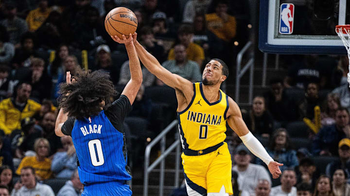 Nov 19, 2023; Indianapolis, Indiana, USA; Orlando Magic guard Anthony Black (0) shoots the ball while Indiana Pacers guard Tyrese Haliburton (0) defends in the first quarter at Gainbridge Fieldhouse. Mandatory Credit: Trevor Ruszkowski-Imagn Images