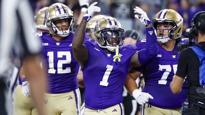 Aug 31, 2024; Seattle, Washington, USA; Washington Huskies running back Jonah Coleman (1) celebrates with wide receiver Denzel Boston (12) and offensive lineman D'Angalo Titialii (75) after rushing for a touchdown against the Weber State Wildcats during the third quarter at Alaska Airlines Field at Husky Stadium. Mandatory Credit: Joe Nicholson-Imagn Images