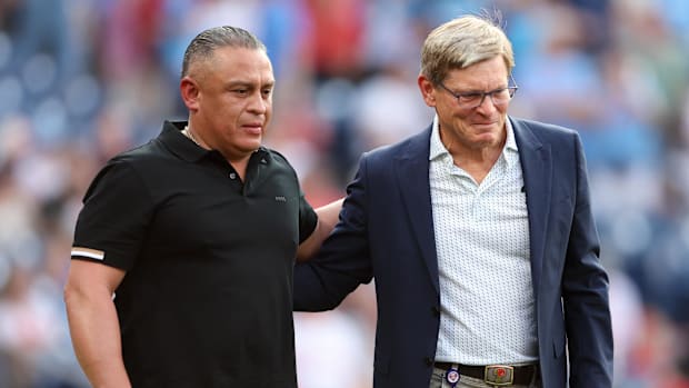 Philadelphia Phillies owner John Middleton (R) and former player Carlos Ruiz (L)