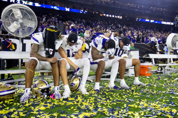 Washington's Ja'Lynn Polk, Jalen McMillan, Dillon Johnson and Ralen Goforthr eact on the bench after losing to Michigan. 