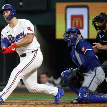 Jun 22, 2024; Arlington, Texas, USA; Texas Rangers left fielder Wyatt Langford (36) reacts after hitting a bal off his foot in the eighth inning against the Kansas City Royals at Globe Life Field. 