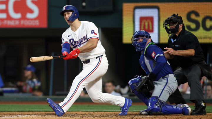 Jun 22, 2024; Arlington, Texas, USA; Texas Rangers left fielder Wyatt Langford (36) reacts after hitting a bal off his foot in the eighth inning against the Kansas City Royals at Globe Life Field. 
