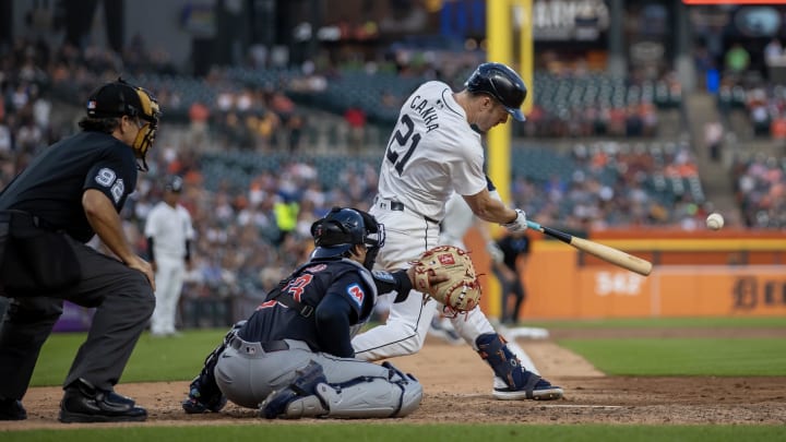 Jul 8, 2024; Detroit, Michigan, USA; Detroit Tigers outfielder Mark Canha (21) hits an infielders choice RBI in the ninth inning against the Cleveland Guardians at Comerica Park. Mandatory Credit: David Reginek-USA TODAY Sports