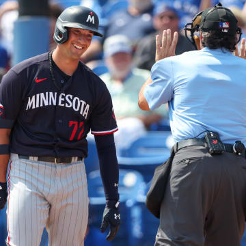 Mar 8, 2023; Dunedin, Florida, USA;  confusion at the plate with Minnesota Twins shortstop Brooks Lee (72) and umpire James Hoye (92) on a timeout and the pitch clock during spring training at TD Ballpark. Mandatory Credit: Nathan Ray Seebeck-USA TODAY Sports