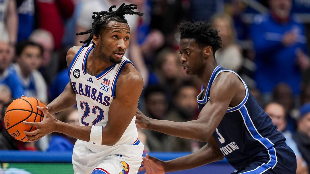 Kansas Jayhawks guard Darryn Peterson (22) looks to pass against BYU Cougars forward AJ Dybantsa (3) Kansas Jayhawks guard Darryn Peterson (22) looks to pass against BYU Cougars forward AJ Dybantsa (3)